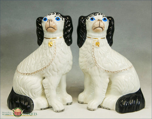 A Pair of Antique English Black and White Victorian Staffordshire Disraeli Spaniels with blue eyes and separate legs, c1860 